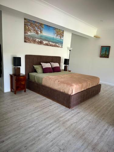 Gold Coast House | One bedroom with shared bathroom ground level of a two-story house