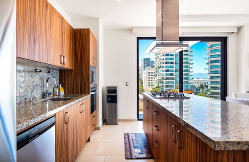 North Hotel Zone Condo | 5th-floor condo with partial ocean views, heated pool, sauna, gym, balcony, W/D
