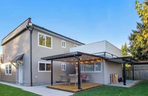 Ladner House | A small studio with a large backyard patio.