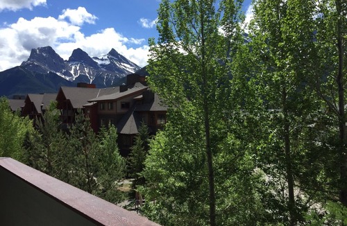 Canmore Condo | Modern, rustic mountain view loft style condo with pool, hot tubs & XL beds.