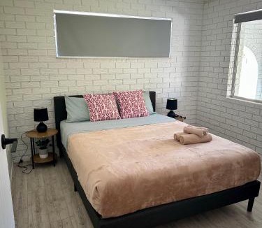 Gold Coast House | One bedroom with shared bathroom ground level of a two-story house