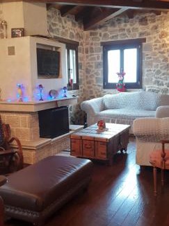 Kato Pedina House | Vargiani Stone Retreat with Fireplace & View